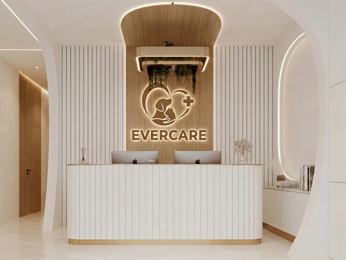 The EverCare Veterinary Clinic reception, with a curved white desk and the clinic logo lit on a wood panel behind it
